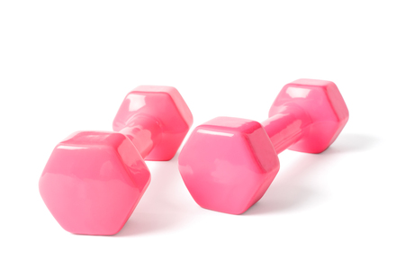 two dumbells covered with pink colored rubber, isolated on white.の写真素材