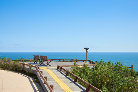 two benches and binoculars at the obserbatory in Oryukdo Park in Busan, Korea. Oryukdo is a famous islands and the park is well-known attraction.の写真素材