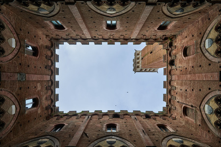 Campanile del Mangia, Looking up view from the inside of Palazzo Pubblico at Piazza del campo in Siena, Tuscany, Italy.のeditorial素材