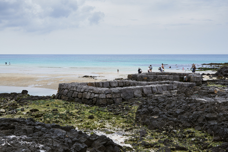 Jeju, Korea - May 23, 2017: Sehwa beach and spring water spot surrounded with basalt stone wall  in Gujwa-eup. it is a small beach becoming famous for serene and calm scenery in recent years.のeditorial素材