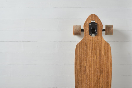 wood pattern drop through type pintail longboard on a white deck backgroundの写真素材