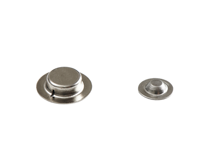 Closeup of button top for battery, isolated on white