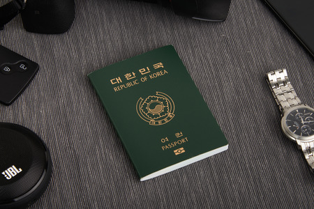 Gimpo, Korea - September 7, 2018: Korean passport at center, surrounded by digital camera, analog watch, smart car key, smartphone and portable bluetooth speakerのeditorial素材
