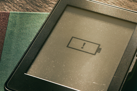 low battery icon on e-book e-reader screen with warm sunlightの写真素材