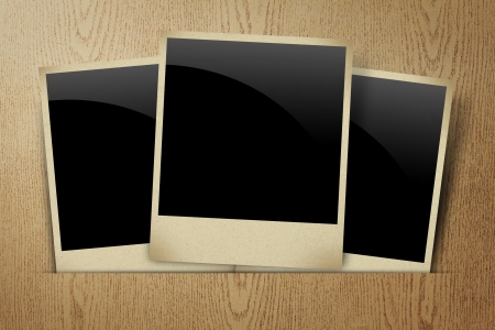 Blank old frame photo on wood texture backgroundの写真素材