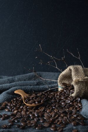 Coffee beans on vintage black fabric background.の写真素材