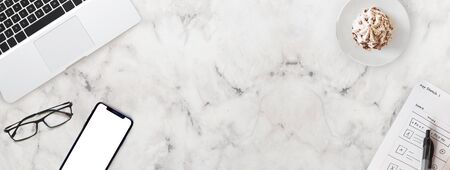 Top view of Business office working marble desk with smartphone, laptop, glasses and coffee,...