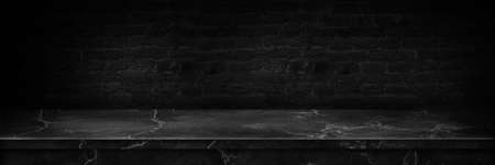 Empty top of natural stone shelves and cement wall background. Empty marble black table top cement black.の写真素材