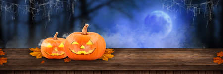 Halloween holiday concept. Wooden old table in a shape of wooden blurred forest background product placement or montage with focus to the table top in the foreground. shelvesの写真素材