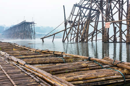 Broken Mon Bridge in Sangkhlaburi District,Kanchanaburi,Thailand , in early misty morning  The bridge will be reconstructed from the crash after the flood  in summer  の写真素材