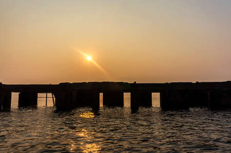 Underwater Temple Sillouette during the sunrise in Sangkhlaburi District,Kanchanaburi Province, Thailand  の写真素材