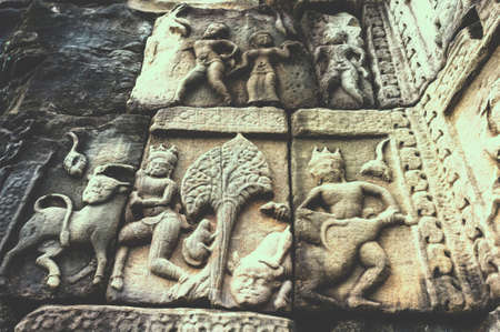 SIEM REAP,CAMBODIA - OCTOBER 23, 2013   The old ancient sculpture carved on a stone at Baphuon in vintage style filter are still in perfect conditionのeditorial素材