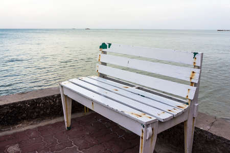 White bench along the sea in Hua Hin District, Prachuab Kiri Khan, Thailand after the sunsetの写真素材