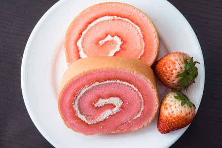 Strawberry jam roll cakes for coffee breakの写真素材