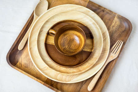 Set of wooden tableware- plates,tray,coffee cup ,spoon and forkの写真素材