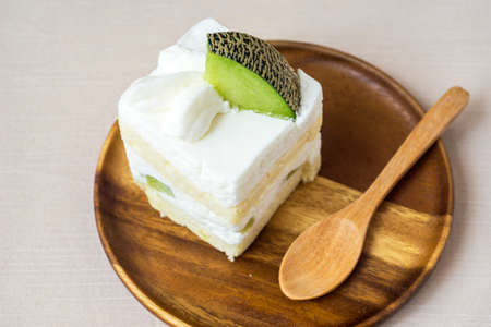 White melon cake on wooden plateの写真素材
