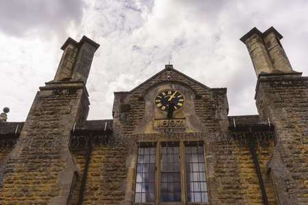 GLOUCESTERSHIRE,ENGLAND-AUGUST 5,2016 : The Victoria Hall, one of the old building dated back in 1897, in Cotswolds, Bourton on the Water ( vintage filter applied).のeditorial素材