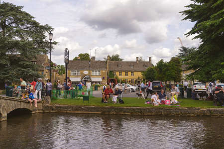 GLOUCESTERSHIRE,ENGLAND-AUGUST 5,2016 : Bourton on the Water was one of popular place for picnic in summer.のeditorial素材