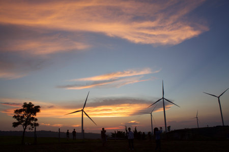 Silhouette of wind turbines at sunset in the countryside of Thailand.の写真素材