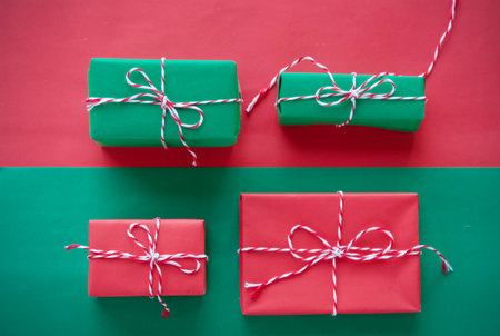 Gift boxes in red, green and red on a green backgroundの写真素材