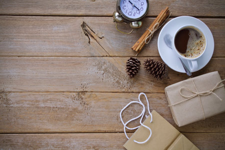 Cup of coffee and christmas gift box on wooden background.の写真素材