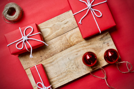 Red christmas gift boxes on wooden background. Top view with copy space