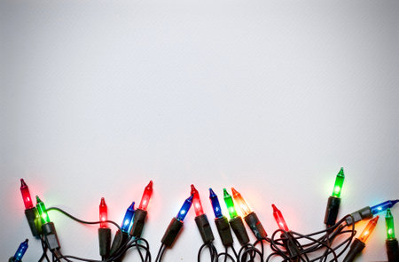 Colorful christmas lights on white background with copy space for textの写真素材