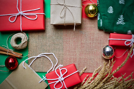 Christmas background with gift boxes and ornaments on sackcloth.