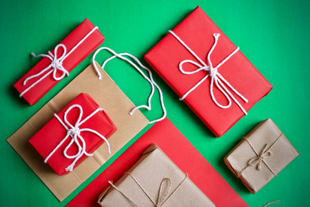 Christmas or New Year gift boxes on green background. Flat lay, top view.