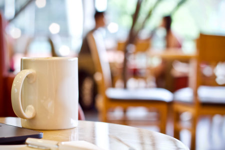 Coffee cup on wooden table in coffee shop cafe, stock photoの写真素材