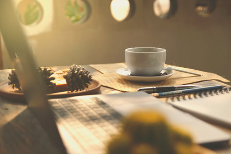 Coffee cup on wooden table in coffee shop, stock photoの写真素材