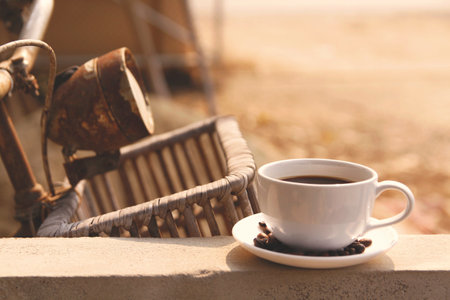Coffee cup and vintage bicycle on the terrace in the morningの写真素材