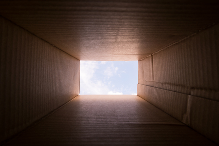 Concept image Thinking Outside the Box - Lateral Thinking for Innovation - Inside a cardboard box...