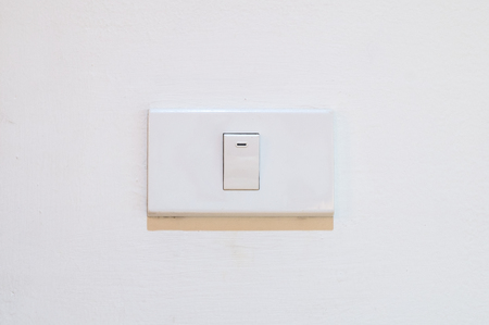 White light switch on white wall - ON OFF electrical Light switch - Home Concept