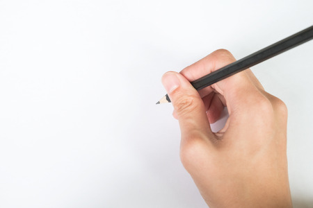 Hand writing something by Pencil in white paper (Background) on the Deskの写真素材