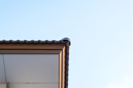 under the Roof of a House with Blue Sky background