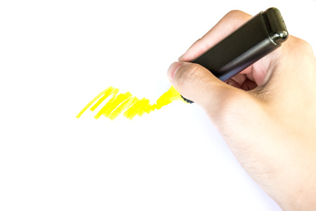 right hand use yellow highlight pen on white paper