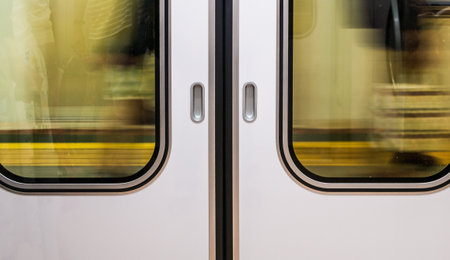windows train while moving from station with motion blurの写真素材