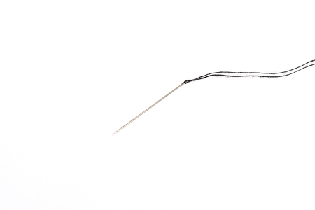 needle for sewing with black thread isolated on white background