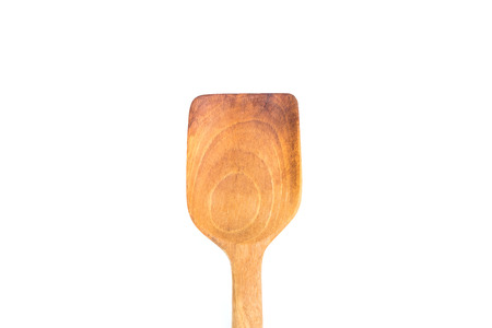 Close-up of wooden flipper use in frying pan isolated on white backgroundの写真素材