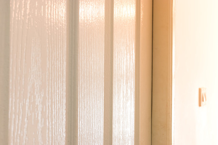 wooden white door in modern house with light for backgroundの写真素材