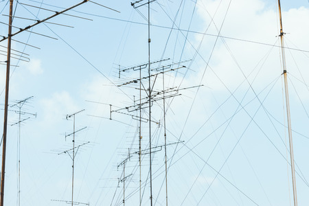 many television antenna with blue sky