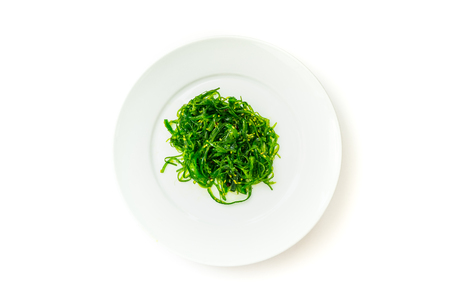 seaweed salad in ceramic plate on white backgroundの写真素材