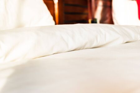 close-up of blanket with pillows in bedroom