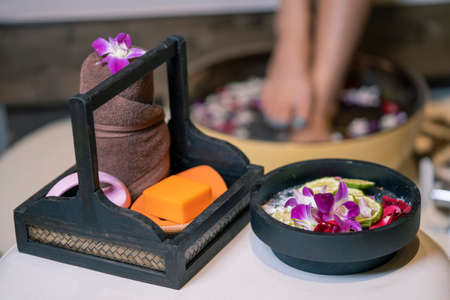 Closeup photo of a female feet at spa salon on pedicure procedure.Spa Wellness Decorations items.Essentials oils and natural products.の写真素材