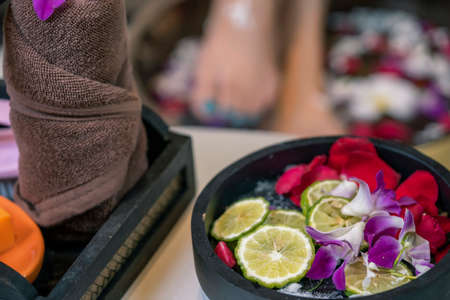 Closeup photo of a female feet at spa salon on pedicure procedure.Spa Wellness Decorations items.Essentials oils and natural products.の写真素材