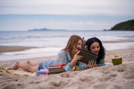 Women LGBT Relationship summer holiday on the beach.