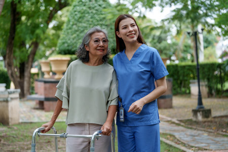 Caregiver provides assistance and support to senior in park, showcasing importance of care and...
