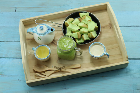 Top table of Pandan Custard served with milk tea and breadの写真素材