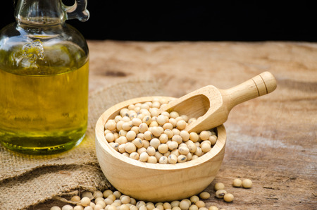 Soy bean and soy oil on wooden table.の写真素材